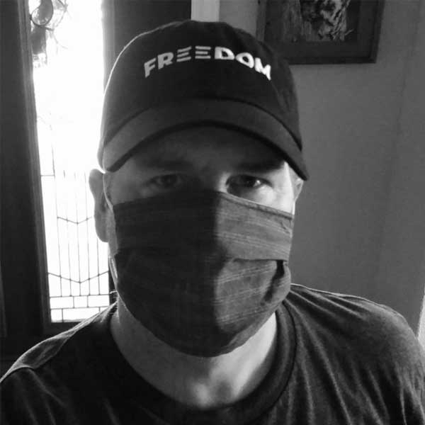 Picture of the author wearing a Freedom baseball cap supporting Black Lives Matter and a cloth face mask used as protection from covid-19.